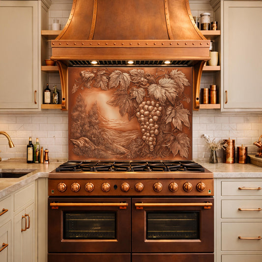 May include: A copper range hood and stove with a grape vine relief design. The range hood is above the stove, which has multiple burners and oven doors. The kitchen has light-colored cabinets and a white tile backsplash.