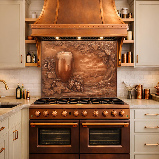 May include: A copper range hood and backsplash with a relief of a beer glass, grapes, and a landscape. The kitchen features a brown oven, light-colored cabinets, and a white tile backsplash. The overall design is rustic and elegant.