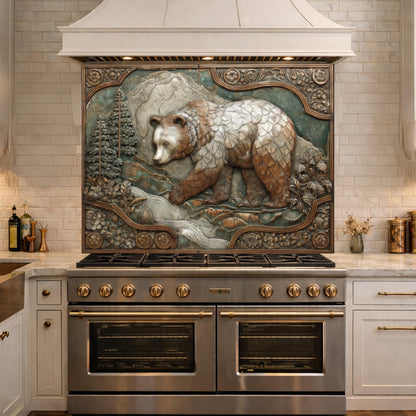 May include: A detailed, carved relief depicting a bear in a forest scene. The artwork, with brown, white, and gray tones, is framed with ornate detailing and mounted above a stainless steel range. The kitchen features white cabinets and a light-colored countertop.